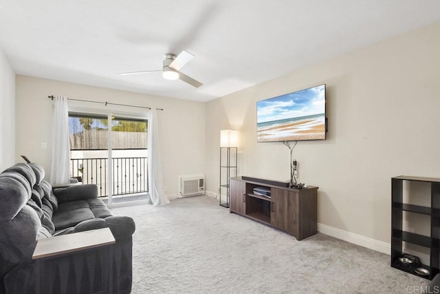 living area featuring ceiling fan, baseboards, and carpet