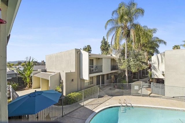 view of swimming pool with a fenced in pool and fence