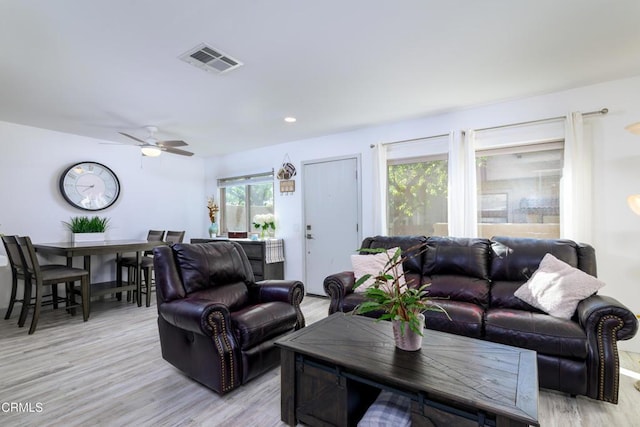 living area with recessed lighting, visible vents, a ceiling fan, and light wood finished floors