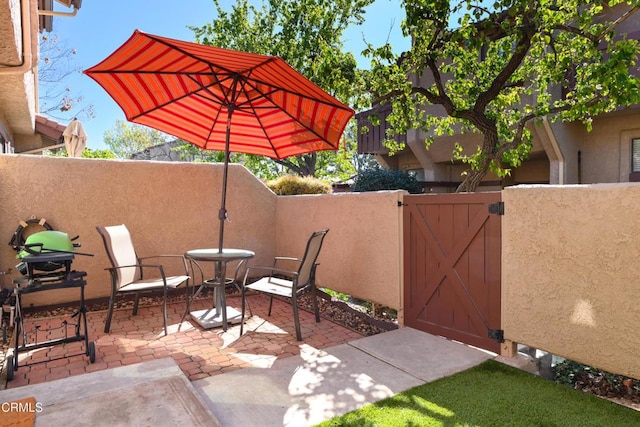 view of patio / terrace featuring a gate and fence