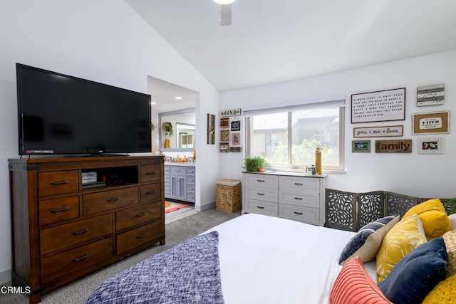 bedroom featuring a ceiling fan, vaulted ceiling, carpet, and connected bathroom