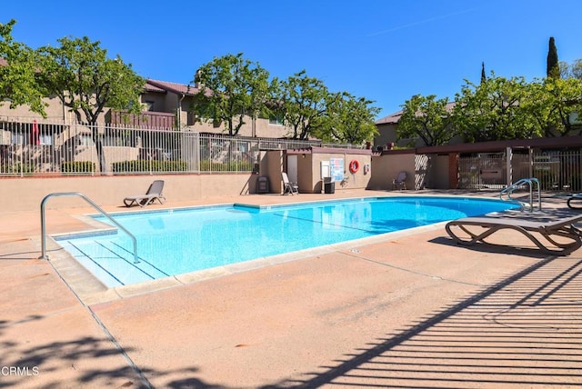 community pool featuring a patio area and fence