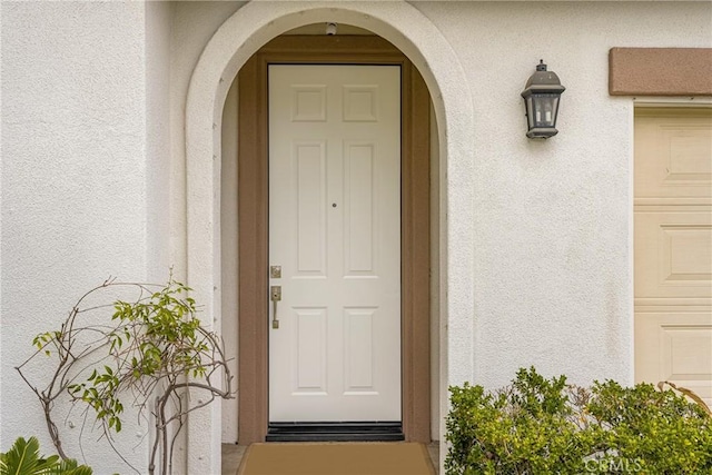 doorway to property with stucco siding