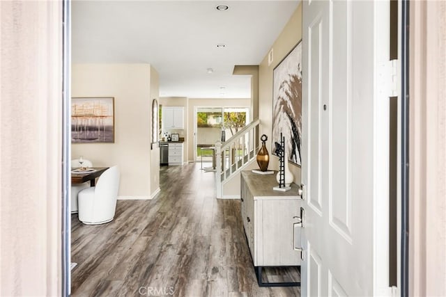 foyer with dark wood-style floors, stairs, and baseboards