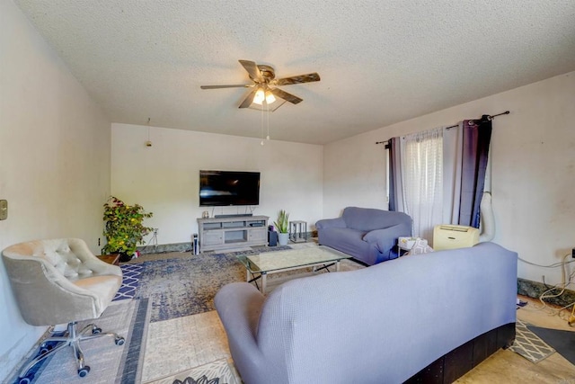 living room with a textured ceiling and ceiling fan