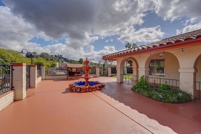 view of patio featuring fence and a gate