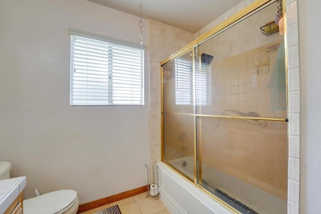 bathroom with vanity, baseboards, bath / shower combo with glass door, tile patterned floors, and toilet