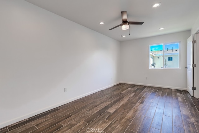 spare room with recessed lighting, baseboards, and dark wood-style floors