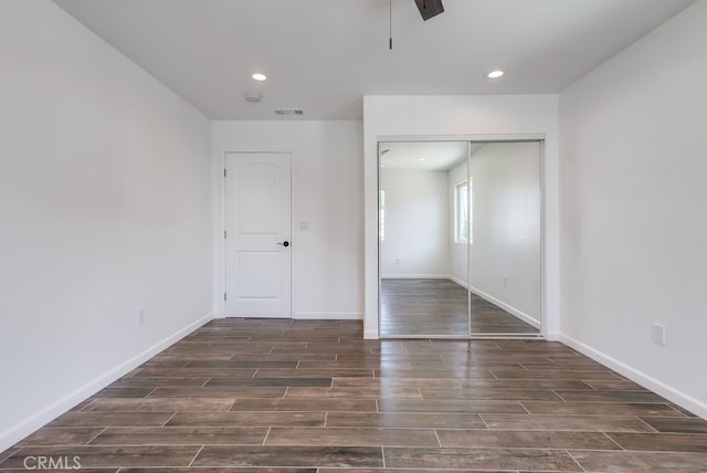 unfurnished bedroom with visible vents, recessed lighting, a closet, baseboards, and wood tiled floor