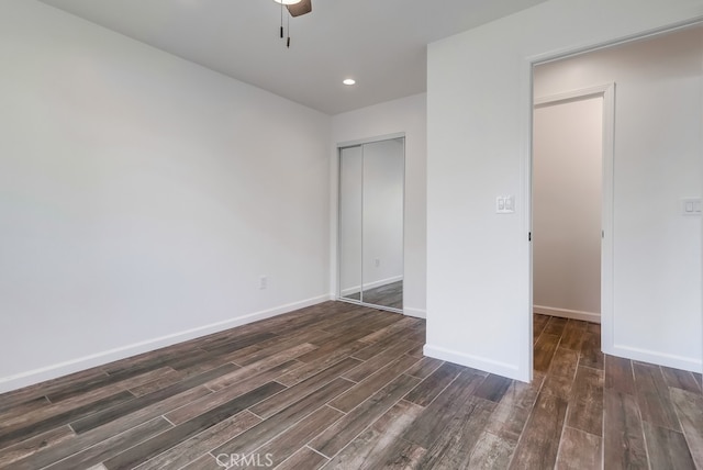 unfurnished bedroom featuring baseboards, recessed lighting, ceiling fan, dark wood-type flooring, and a closet