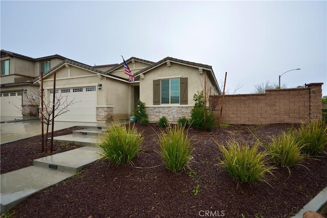 view of front facade featuring a garage, stone siding, driveway, and stucco siding