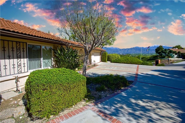 exterior space featuring a tile roof and a mountain view