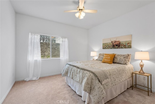 bedroom featuring ceiling fan, baseboards, and carpet