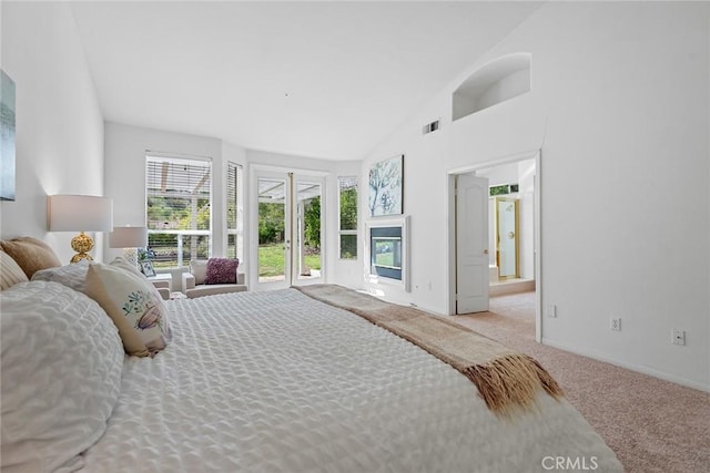 carpeted bedroom featuring visible vents, high vaulted ceiling, ensuite bathroom, access to outside, and baseboards