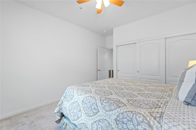 bedroom featuring a closet, baseboards, carpet, and a ceiling fan