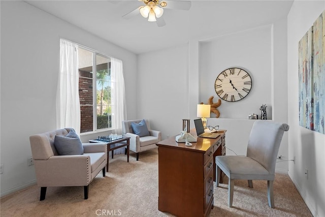 carpeted home office with baseboards and a ceiling fan