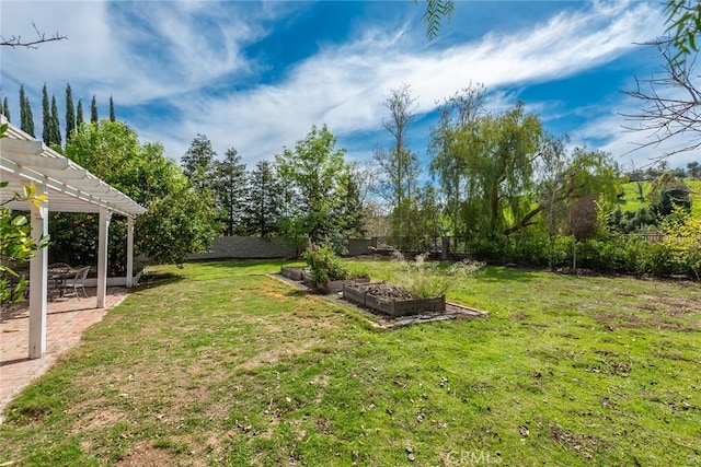 view of yard featuring a patio area, a garden, a fenced backyard, and a pergola