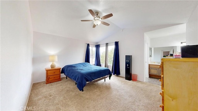 carpeted bedroom with ensuite bathroom, ceiling fan, and vaulted ceiling