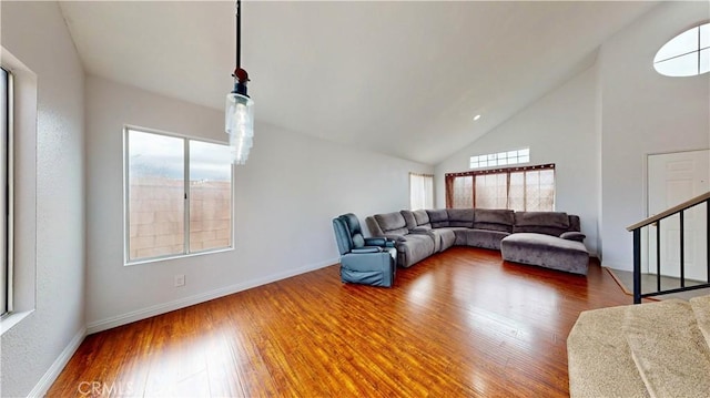 living area featuring stairway, wood finished floors, and baseboards