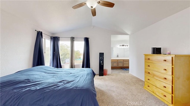 carpeted bedroom with ceiling fan, ensuite bathroom, and vaulted ceiling