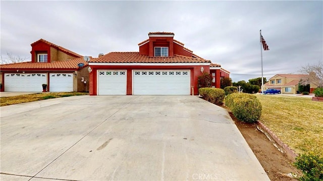 view of front of house with a front lawn, a tiled roof, stucco siding, a garage, and driveway