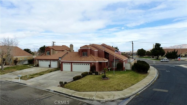 view of front facade featuring a front lawn, a tiled roof, concrete driveway, stucco siding, and a garage