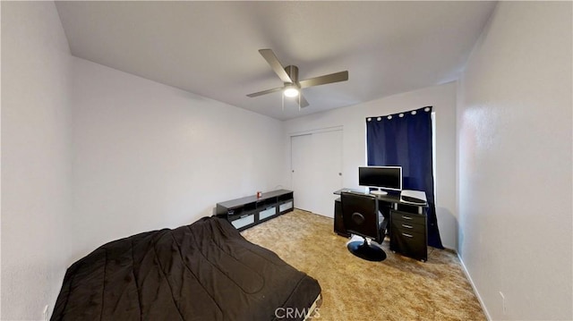 bedroom with a ceiling fan, light colored carpet, and a closet