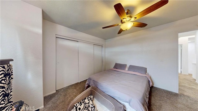 carpeted bedroom with a closet and ceiling fan