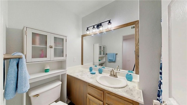 bathroom with toilet and vanity