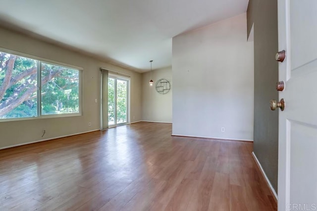 interior space with baseboards and wood finished floors