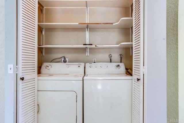 clothes washing area with independent washer and dryer and laundry area