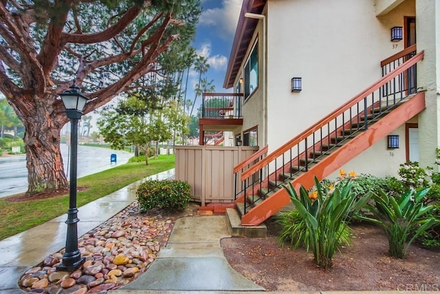 exterior space with stucco siding and stairs