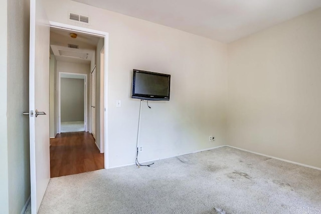 interior space with attic access, visible vents, and carpet floors