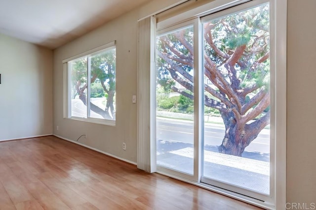 entryway featuring light wood-style floors and baseboards