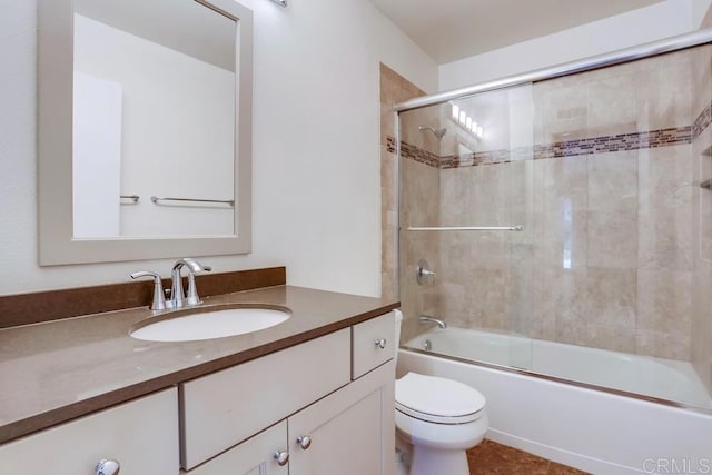 bathroom with enclosed tub / shower combo, toilet, and vanity