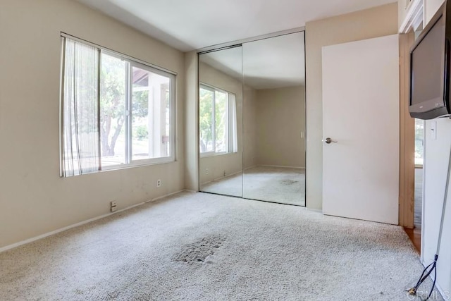 unfurnished bedroom with a closet and carpet floors