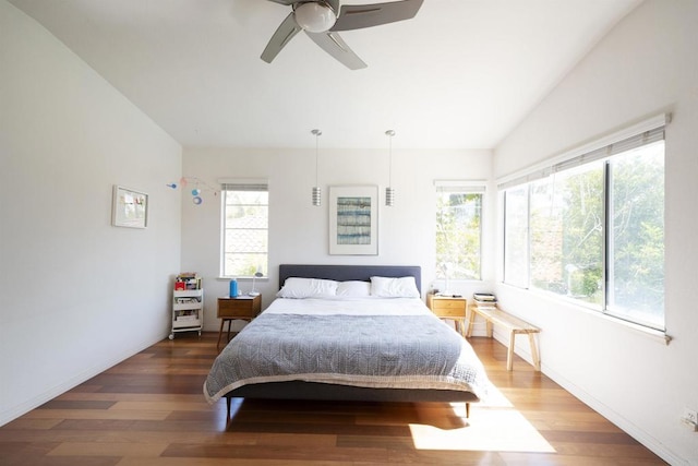 bedroom featuring vaulted ceiling, baseboards, ceiling fan, and wood finished floors