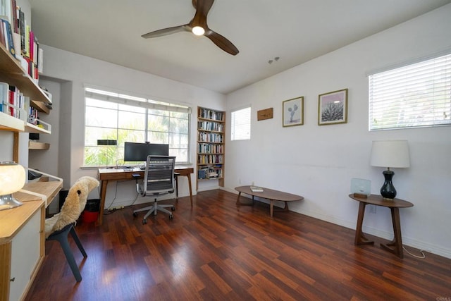 office space with baseboards, plenty of natural light, wood finished floors, and a ceiling fan