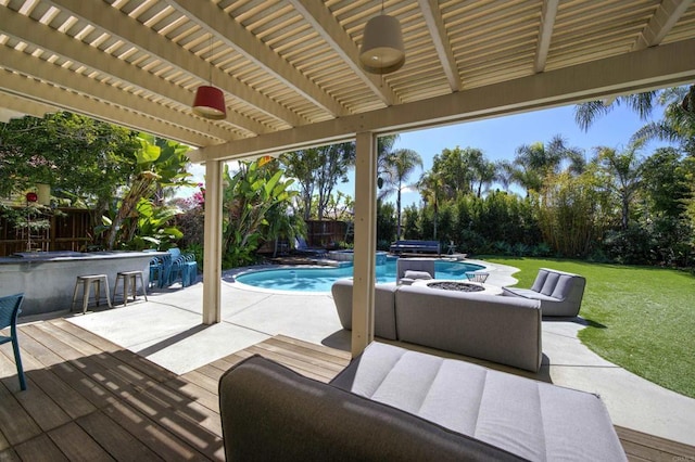 exterior space with outdoor dry bar, a yard, a fenced backyard, a patio area, and a jacuzzi