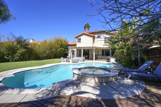 view of swimming pool featuring a pool with connected hot tub, a patio, outdoor lounge area, and a yard