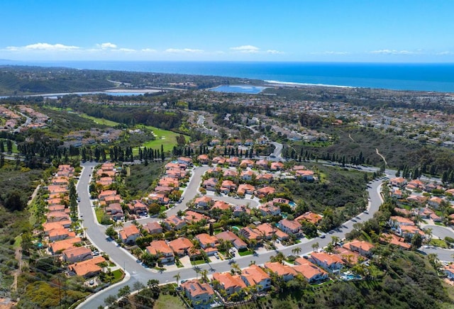 drone / aerial view featuring a residential view and a water view