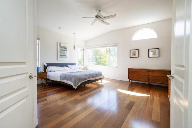 bedroom with ceiling fan, lofted ceiling, and wood finished floors