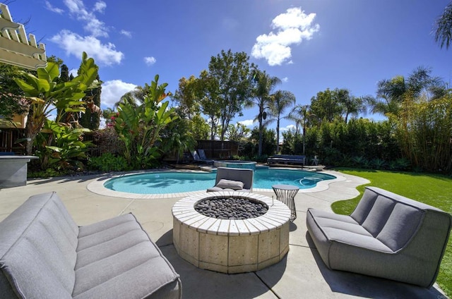 outdoor pool with a fenced backyard, an in ground hot tub, an outdoor hangout area, and a patio