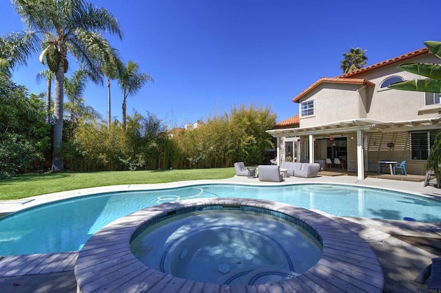 view of swimming pool with a yard, a pool with connected hot tub, outdoor lounge area, and a patio area