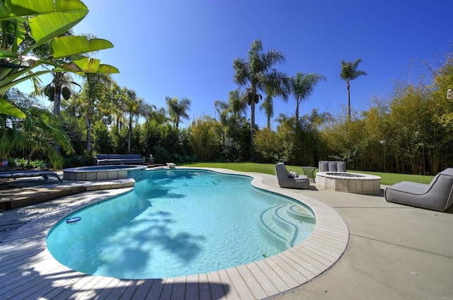 view of swimming pool featuring a patio, a fire pit, and a pool with connected hot tub