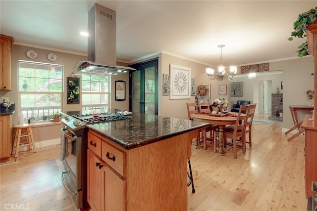 kitchen featuring ornamental molding, gas stove, light wood-type flooring, and island range hood