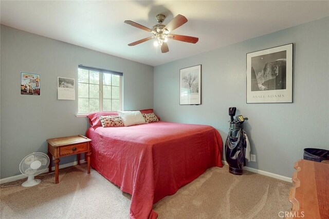 bedroom featuring baseboards, a ceiling fan, and carpet flooring