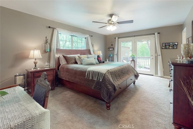 carpeted bedroom with multiple windows, a ceiling fan, and access to outside