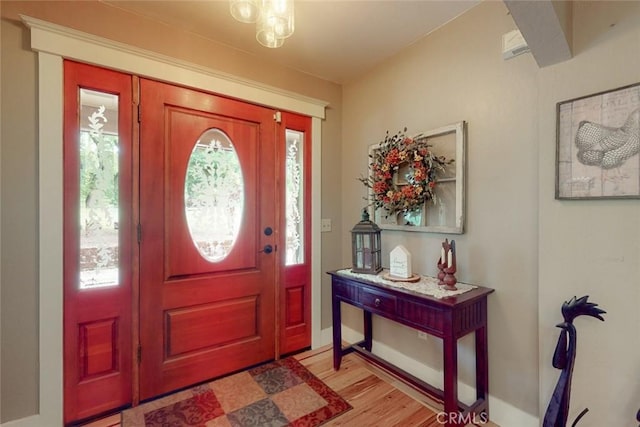 entryway featuring baseboards and light wood-style floors