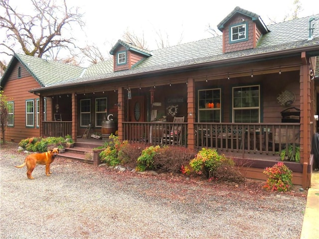 view of front facade featuring a porch and a shingled roof